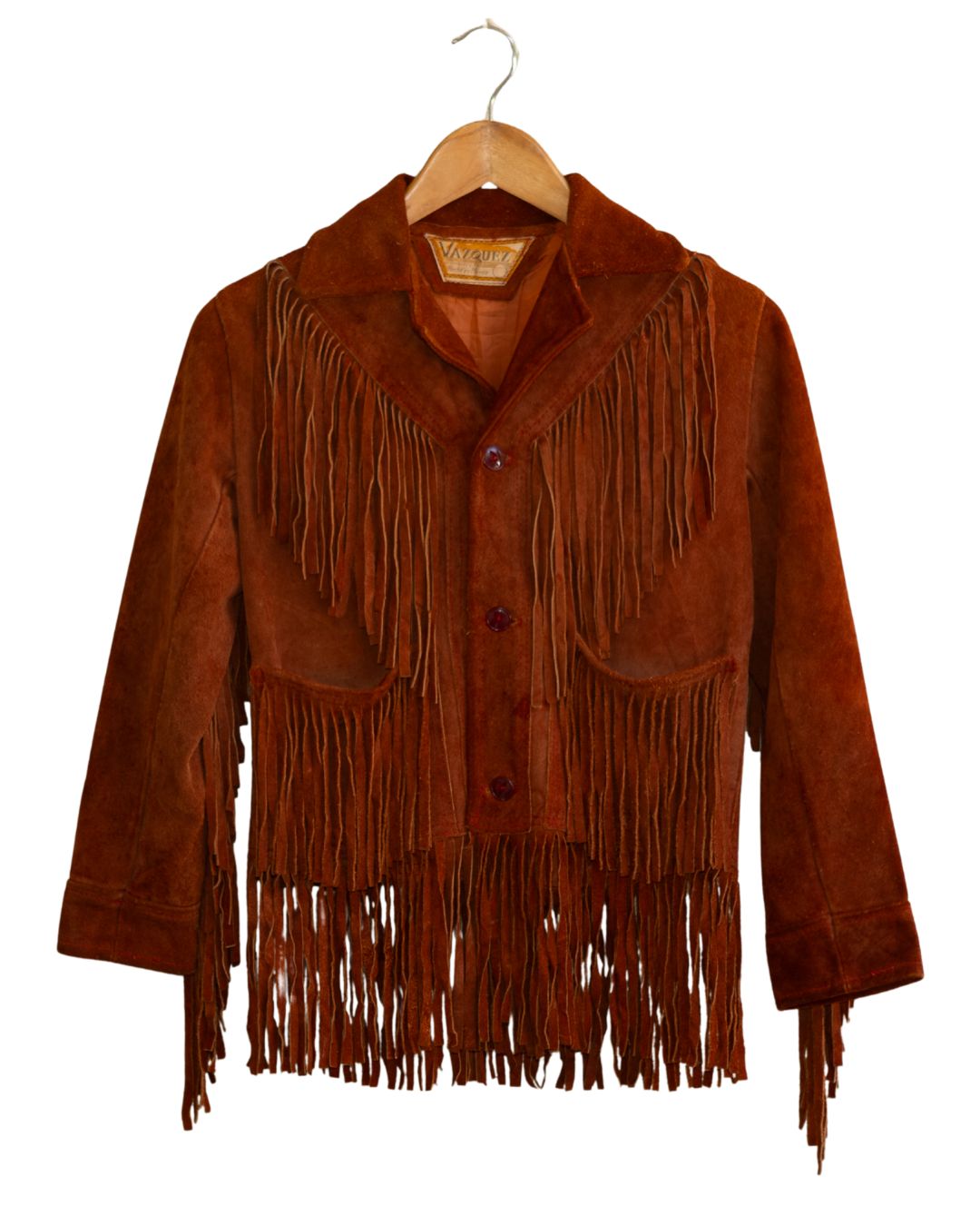 Front view of 1970s burnt orange suede fringe jacket on hanger.