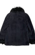 Back view of vintage Georges Rech coat showing black wool texture and dramatic fur-trimmed collar and cuffs.