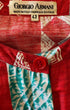 Close-up of Giorgio Armani label on red and aqua Italian cotton dress.