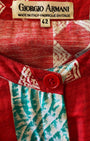 Close-up of Giorgio Armani label on red and aqua Italian cotton dress.