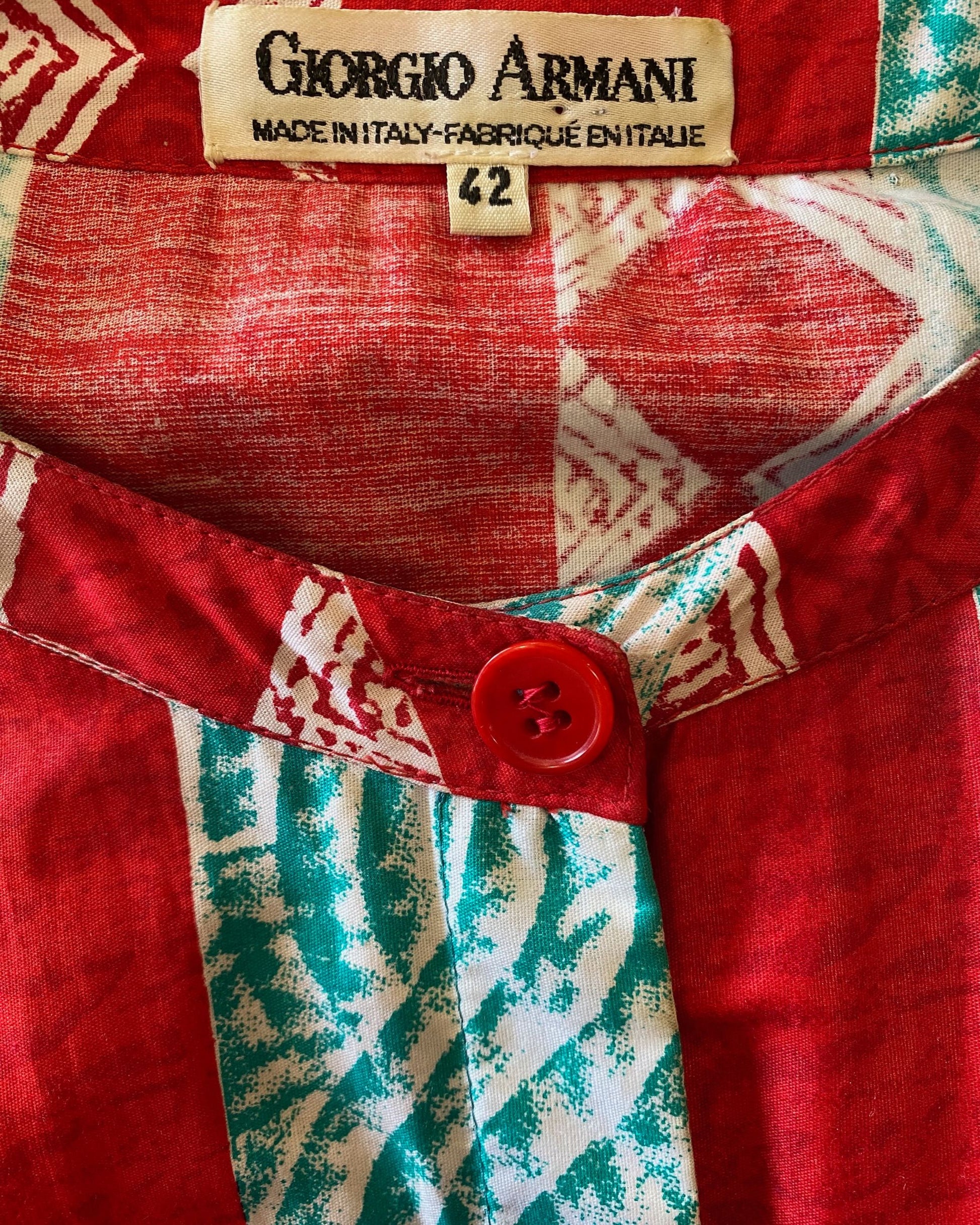 Close-up of Giorgio Armani label on red and aqua Italian cotton dress.