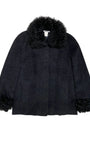 Front view of vintage Georges Rech black coat with curly fur collar and cuffs, made in France, size 42.