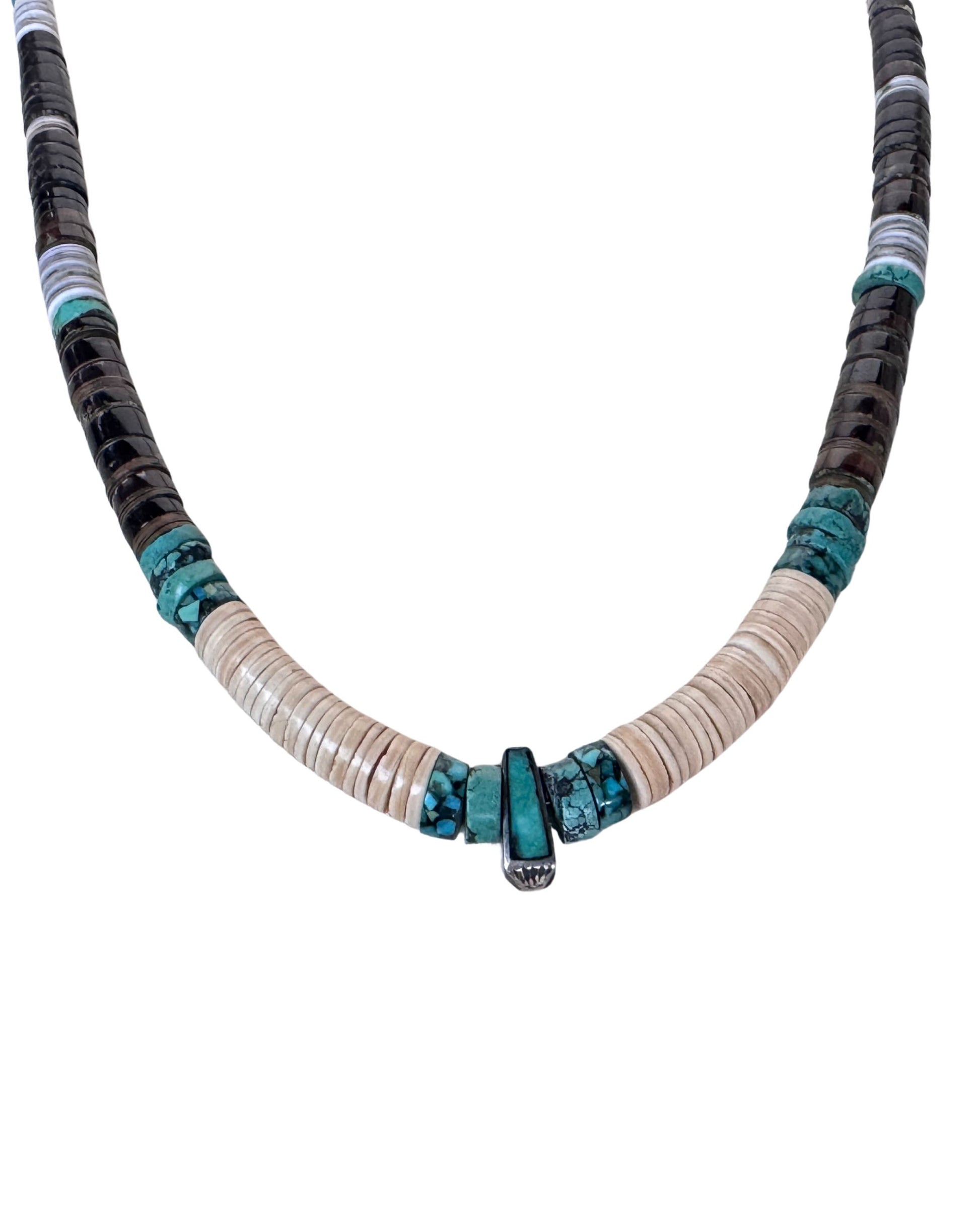 Close-up detail of Southwestern necklace with cream shell heishi, turquoise accents and sterling silver turquoise center drop pendant.
