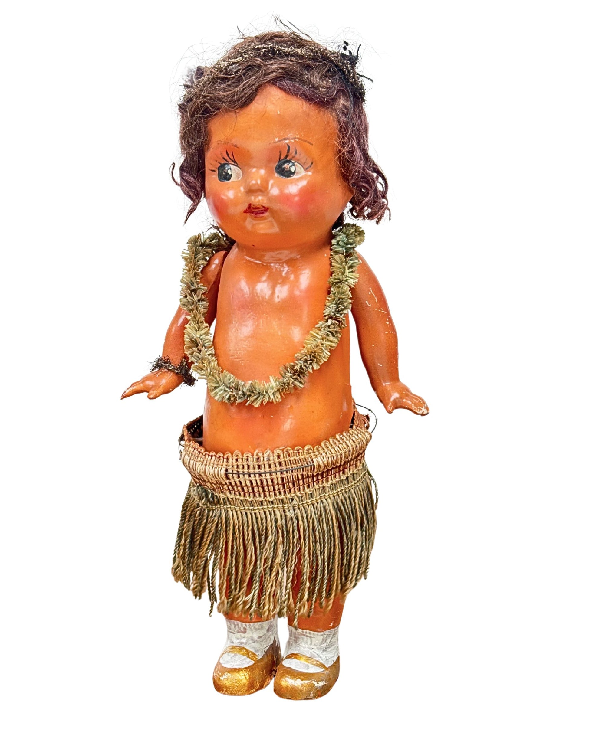1920s mechanical hula girl doll with grass skirt, painted composition face, and wind-up movement.