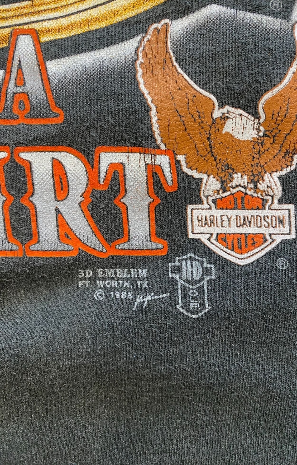 Detail of cracked vintage print showing 1988 3D Emblem mark.