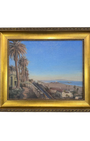 Framed painting of Santa Monica coastal scene with palm trees, blue sky and the Santa Monica Coast in gold frame. 