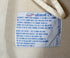 The upclose view of the care label on the Juan Manuel Fangio II Auto Racing Suit.