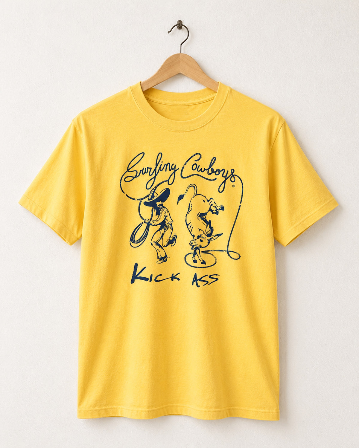 Front view of Surfing Cowboys Kick Ass Adult Classic Crew T-Shirt in California Gold - featuring a Cowboy in sombrero waving a lasso that spells Surfing Cowboys while kicking up his heels as he lassos a dancing donkey.