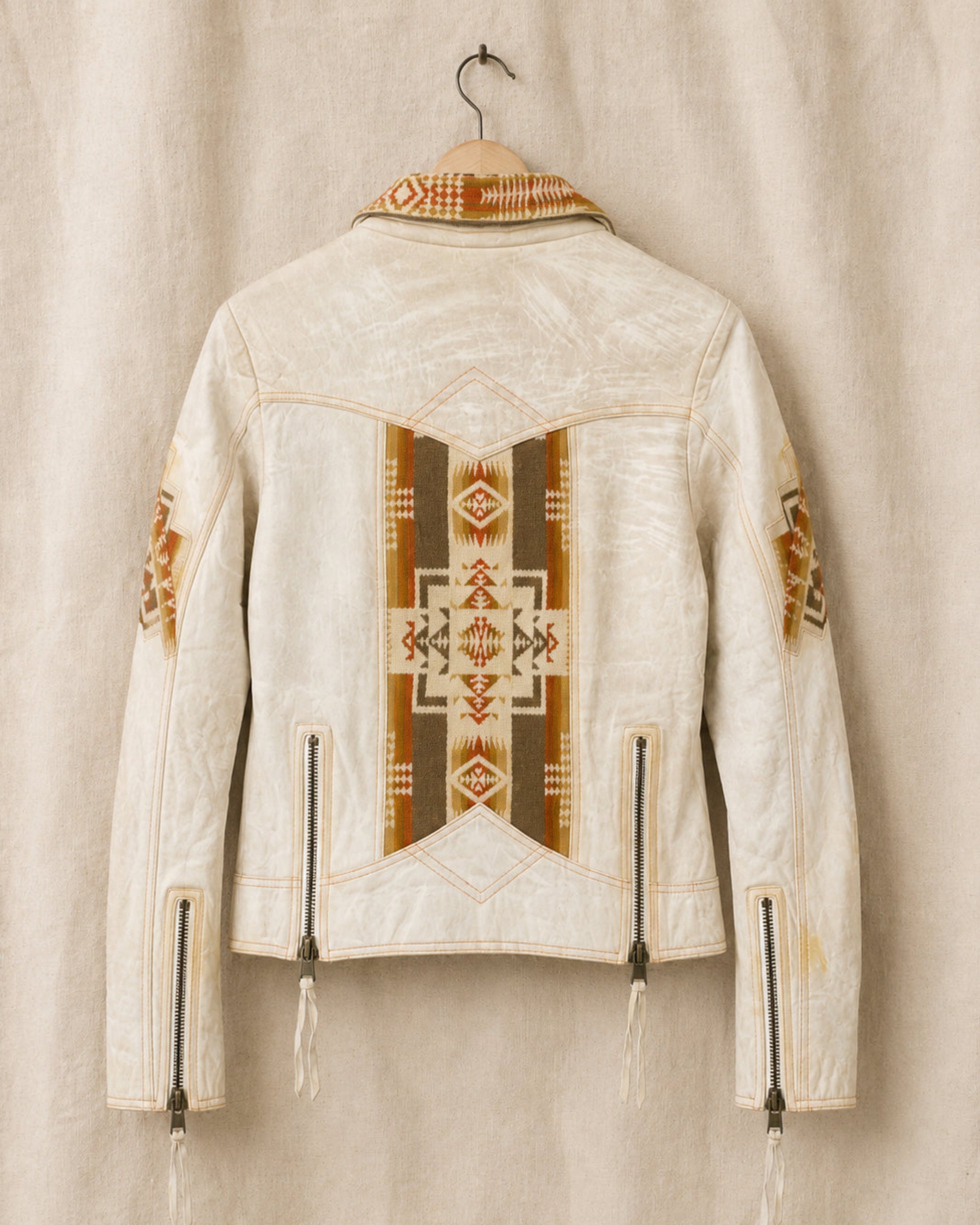 Creamy White leather jacket with geometric patterns on a beige background