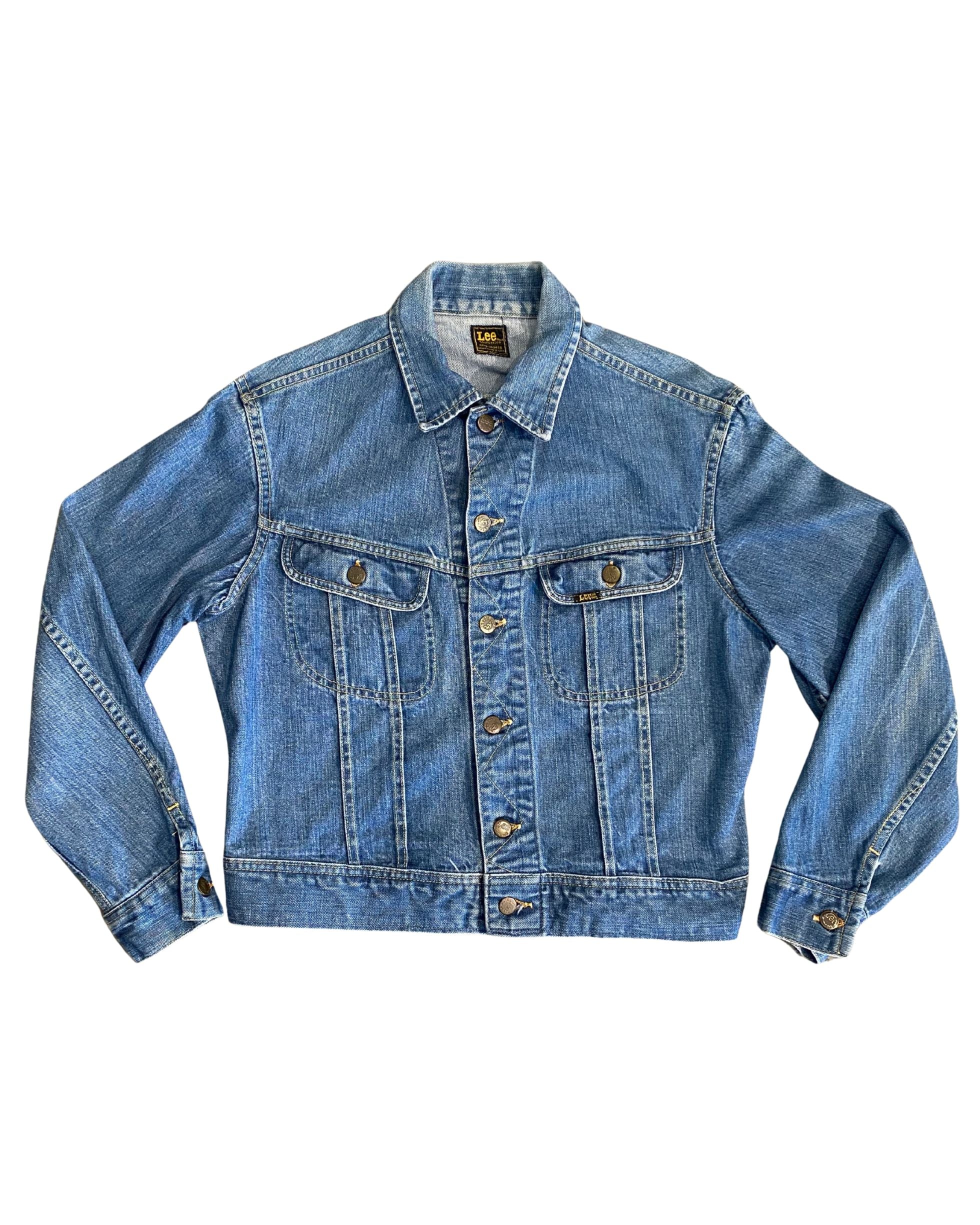 Front of vintage 1970s Lee denim jacket with chest pockets and brass buttons.
