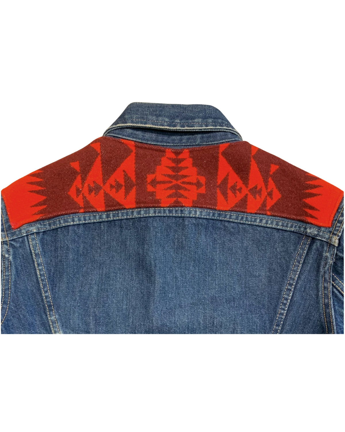• Close-up view of the red Southwestern style wool pattern stitched onto the back yoke of a casual 1970s Lee indigo denim jacket.

