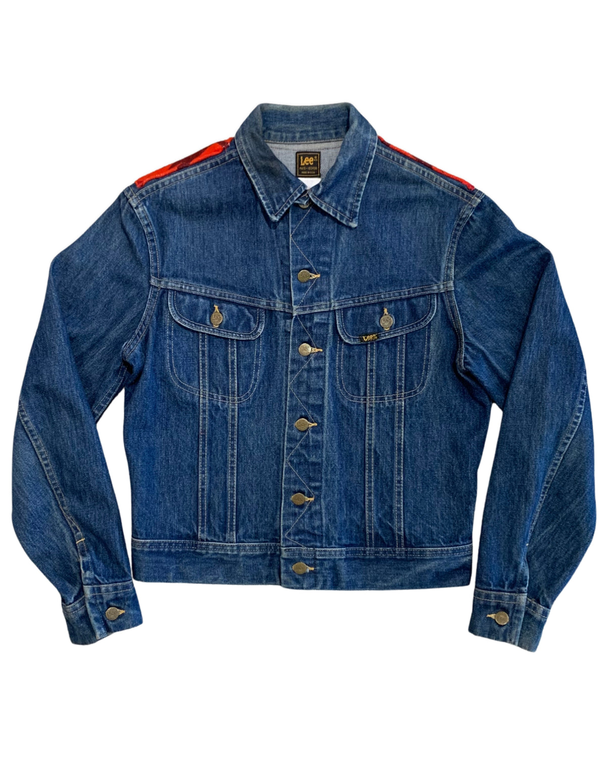 Front view of a casual vintage 1970s Lee denim jacket in a worn indigo wash with classic twin chest pockets and original metal buttons.