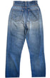 Back view of faded blue Levi’s jeans with two rear pockets, a red tab, worn seams, and repaired areas below the seat.