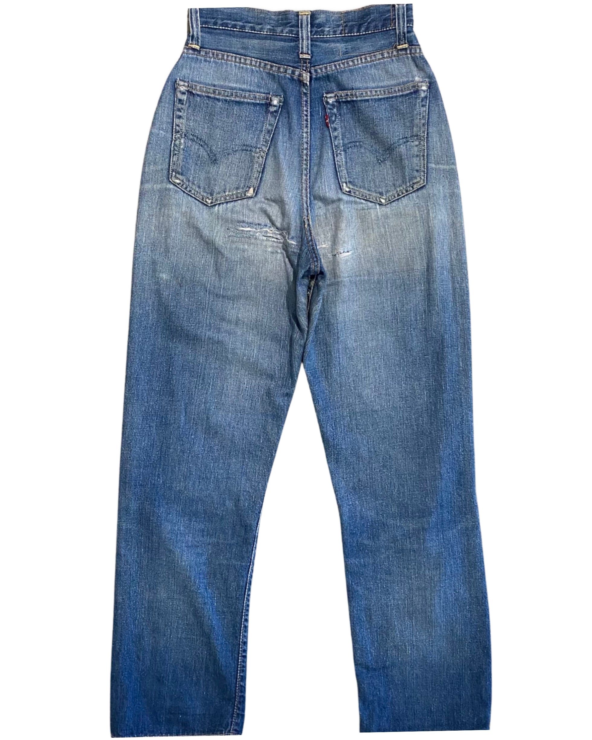 Back view of faded blue Levi’s jeans with two rear pockets, a red tab, worn seams, and repaired areas below the seat.