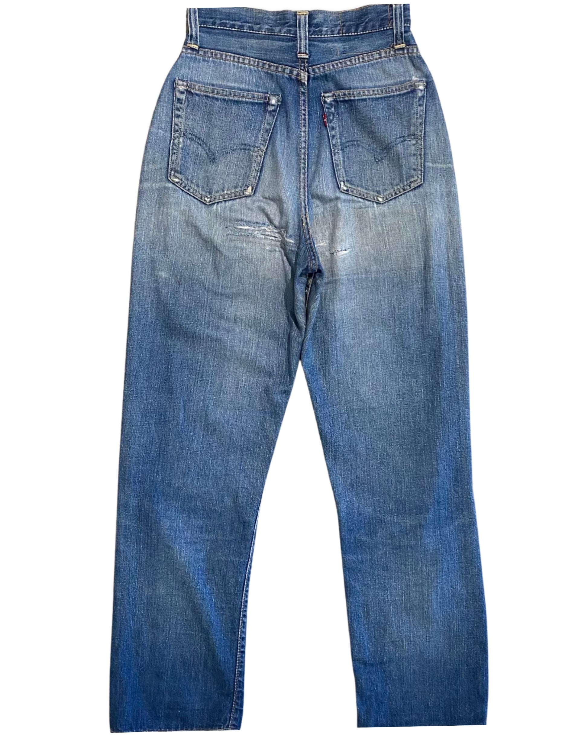 Back view of faded blue Levi’s jeans with two rear pockets, a red tab, worn seams, and repaired areas below the seat.
