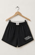 Surfing Cowboys washed black cotton gym shorts with elastic waistband, side pockets, and small logo printed on the front.