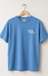 Front of Surfing Cowboys Logo high crew T-shirt in Washed Blue with small front chest logo and larger back logo print both in white ink.