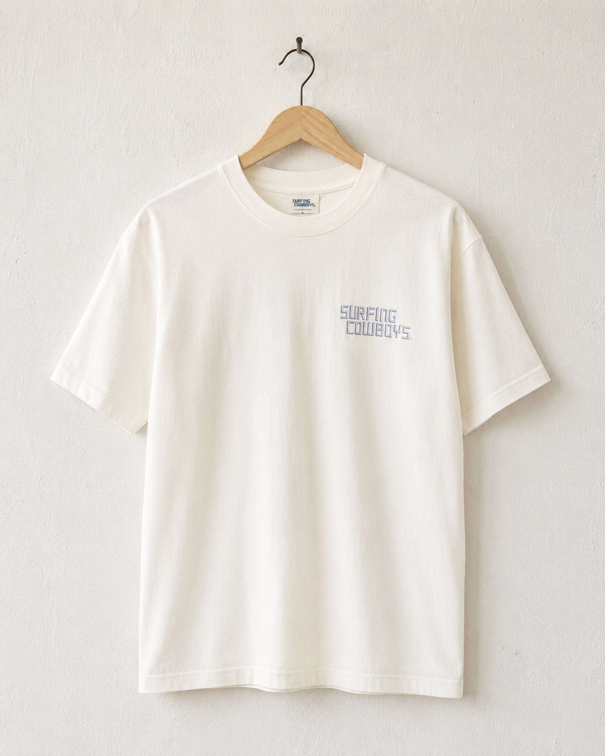 Front of Surfing Cowboys High Crew Cotton Logo T-Shirt in cloud White - view of chest placement printed logo in faded indigo blue.