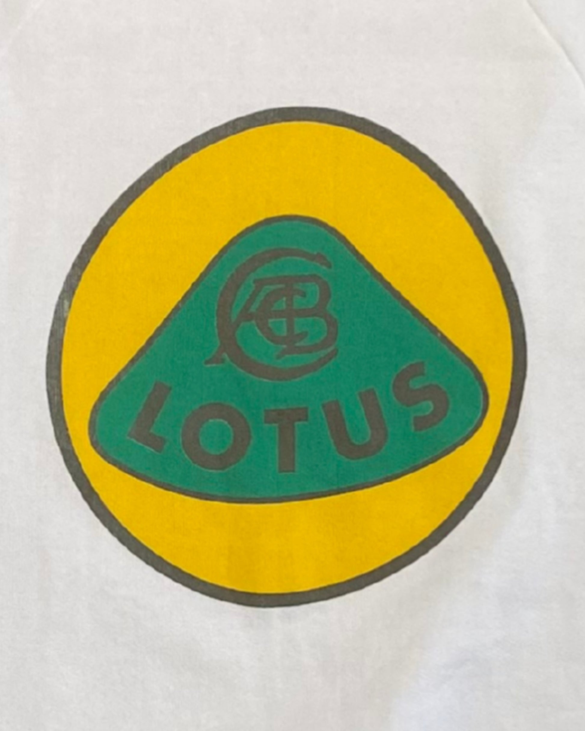 Close-up of the vintage Lotus Cars logo graphic in green and yellow printed on the front of the sweatshirt.