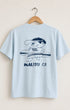 Surfing Cowboys Making Waves High Crew Pocket T-Shirt on hanger displaying back view featuring graphic of surfer boy.