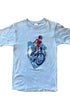 1970s youth T-shirt featuring red motorcycle rider graphic on faded blue cotton. Size 14–16. Vintage Americana style.