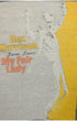 Close-up of the front graphic on a 1970s Rex Harrison My Fair Lady t-shirt displaying stylized artwork, yellow accents, and soft aging across the print.
