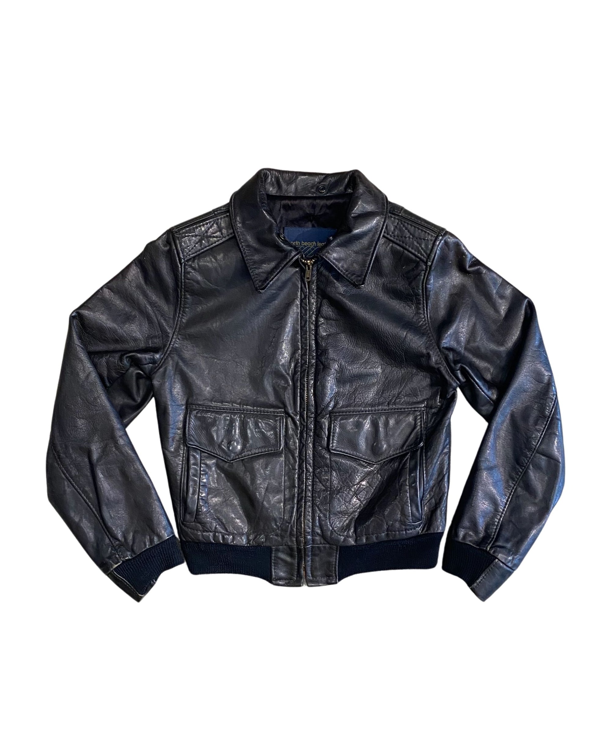 Front of black 1980s North Beach Leather jacket with zip closure.