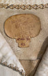 Close-up of North Beach Leather label with handwritten size and serial number.