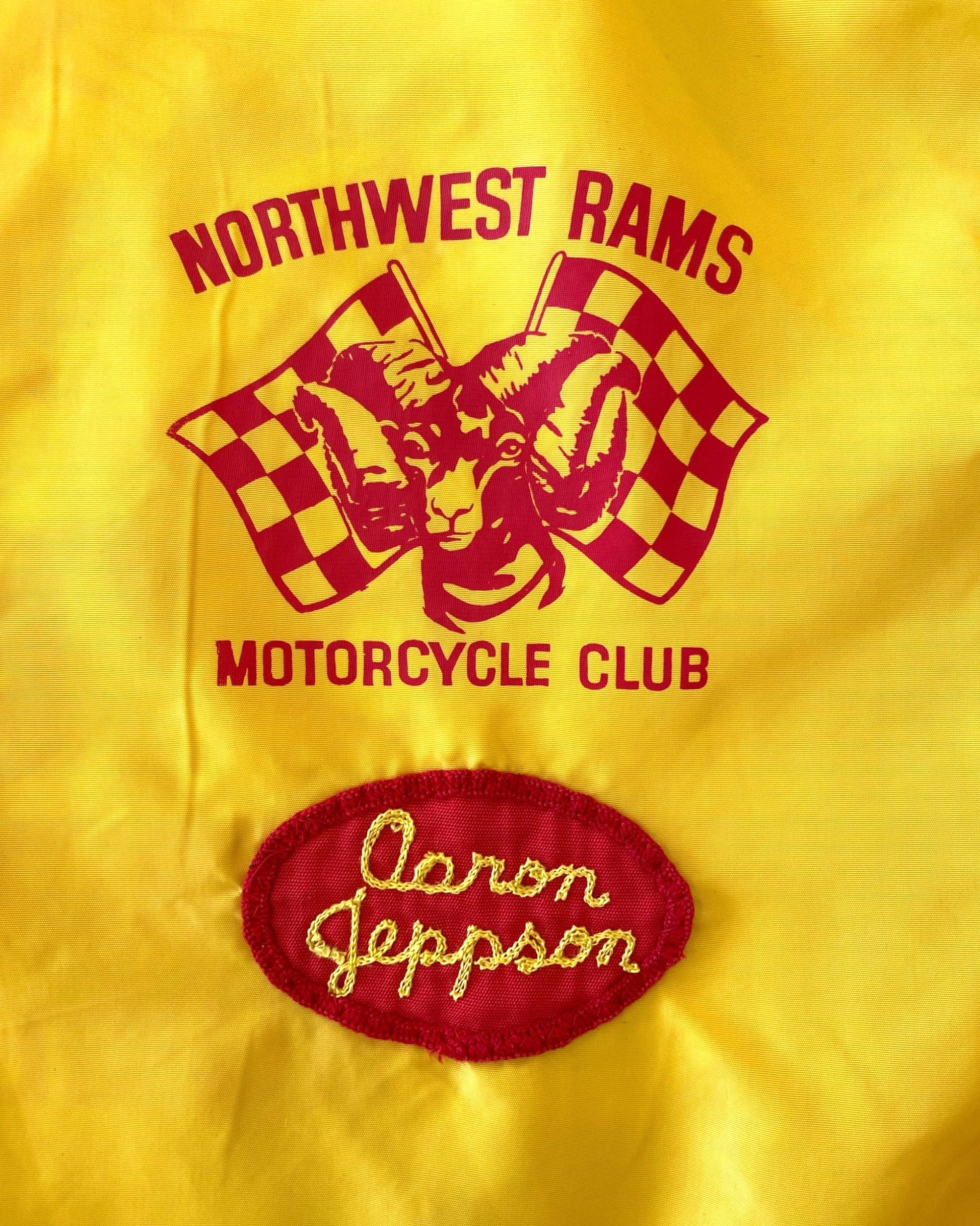 Close-up of embroidered “Aaron Jeppson” name patch on vintage motorcycle jacket.