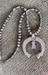 Back of Old Pawn Silver Bead Necklace with Removable Turquoise Naja — Circa 1970s on rustic metal tabletop.