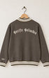 Back view of the mocha brown half-zip sweatshirt highlighting cream embroidered Old Californio typography reading Pacific Palisades curved across the upper shoulders.
