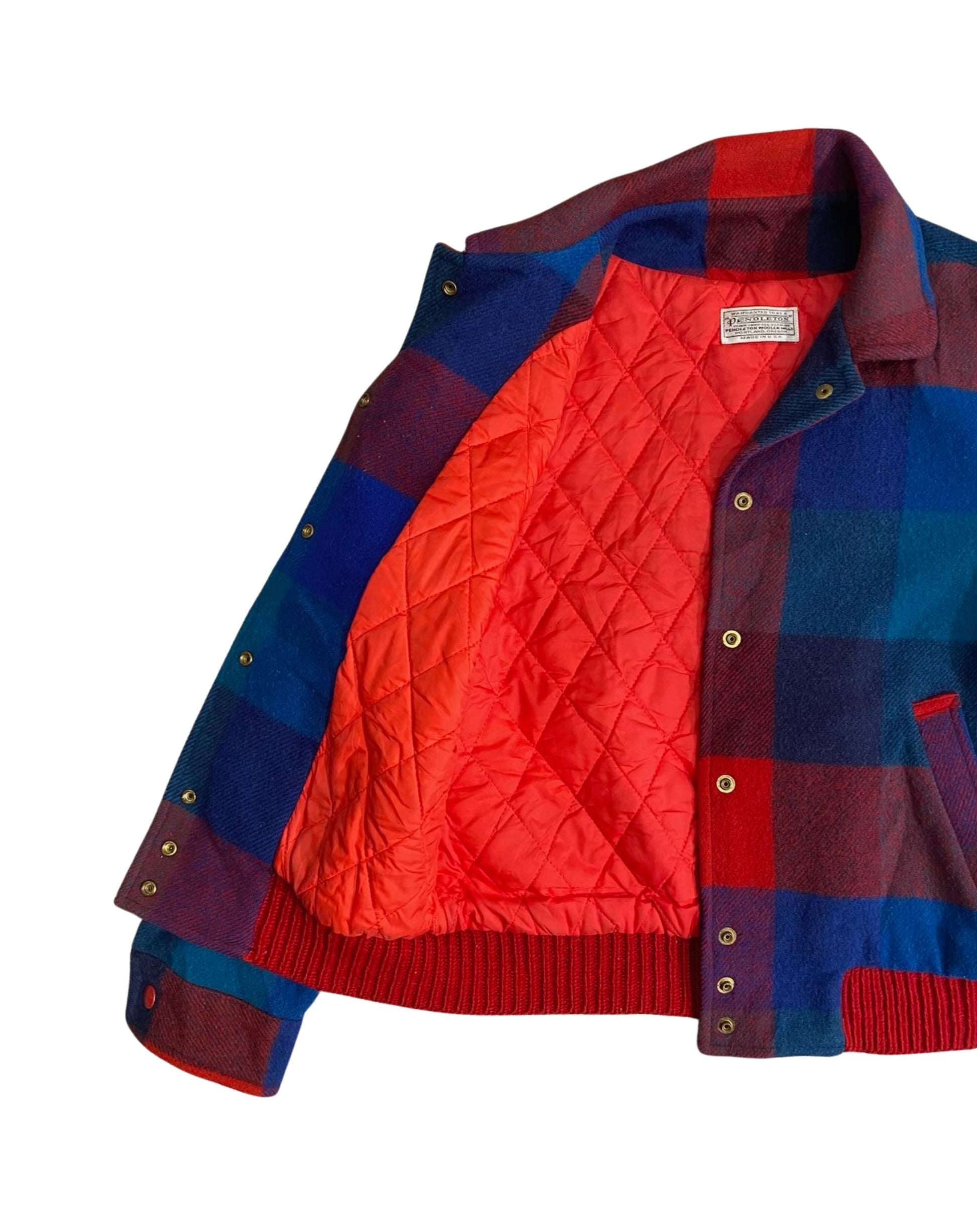 Detail view of snap front and slash pocket on Pendleton jacket.