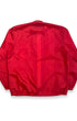 Back view of vintage red Porsche racing jacket with plain red back and elastic hem.
