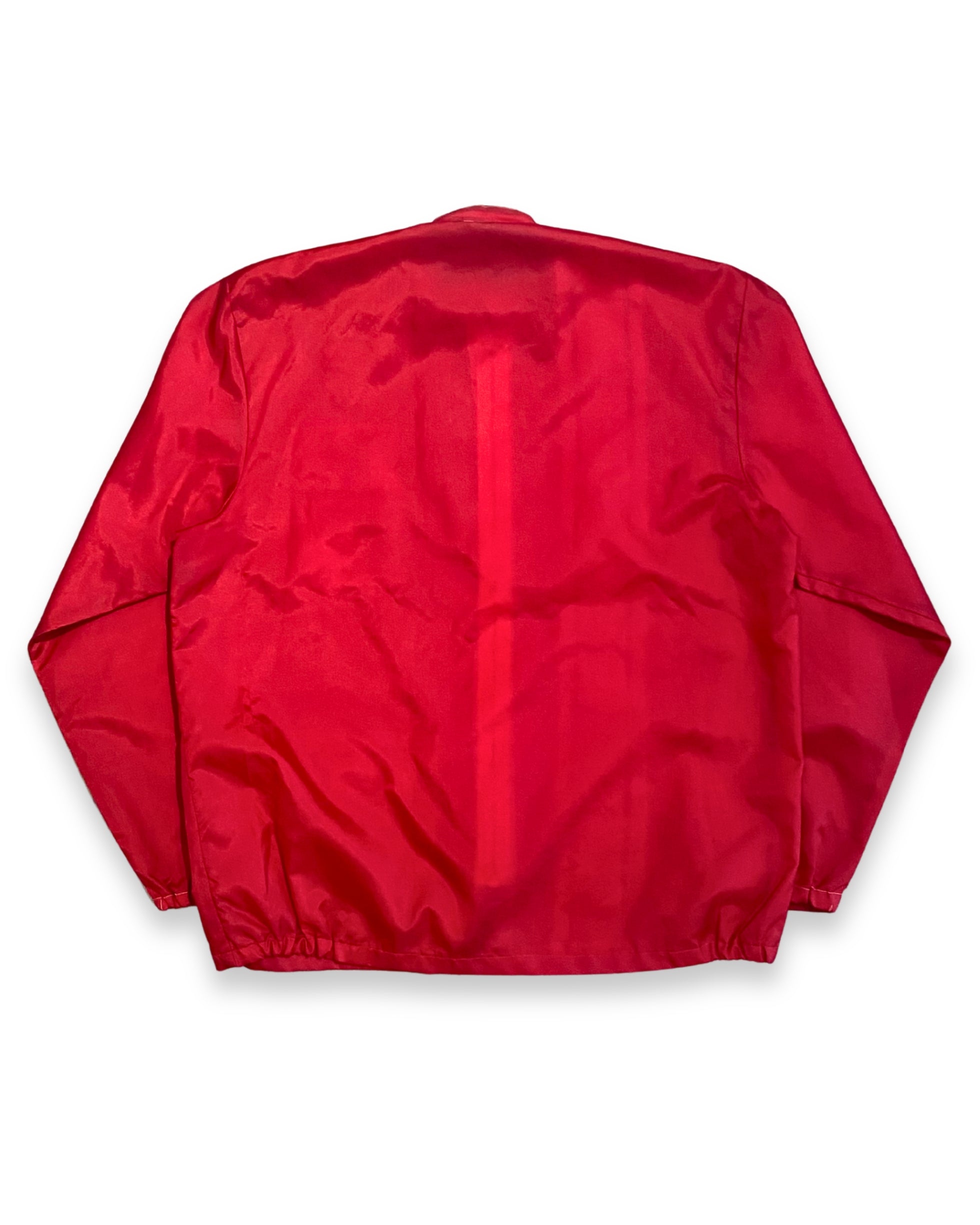 Back view of vintage red Porsche racing jacket with plain red back and elastic hem.
