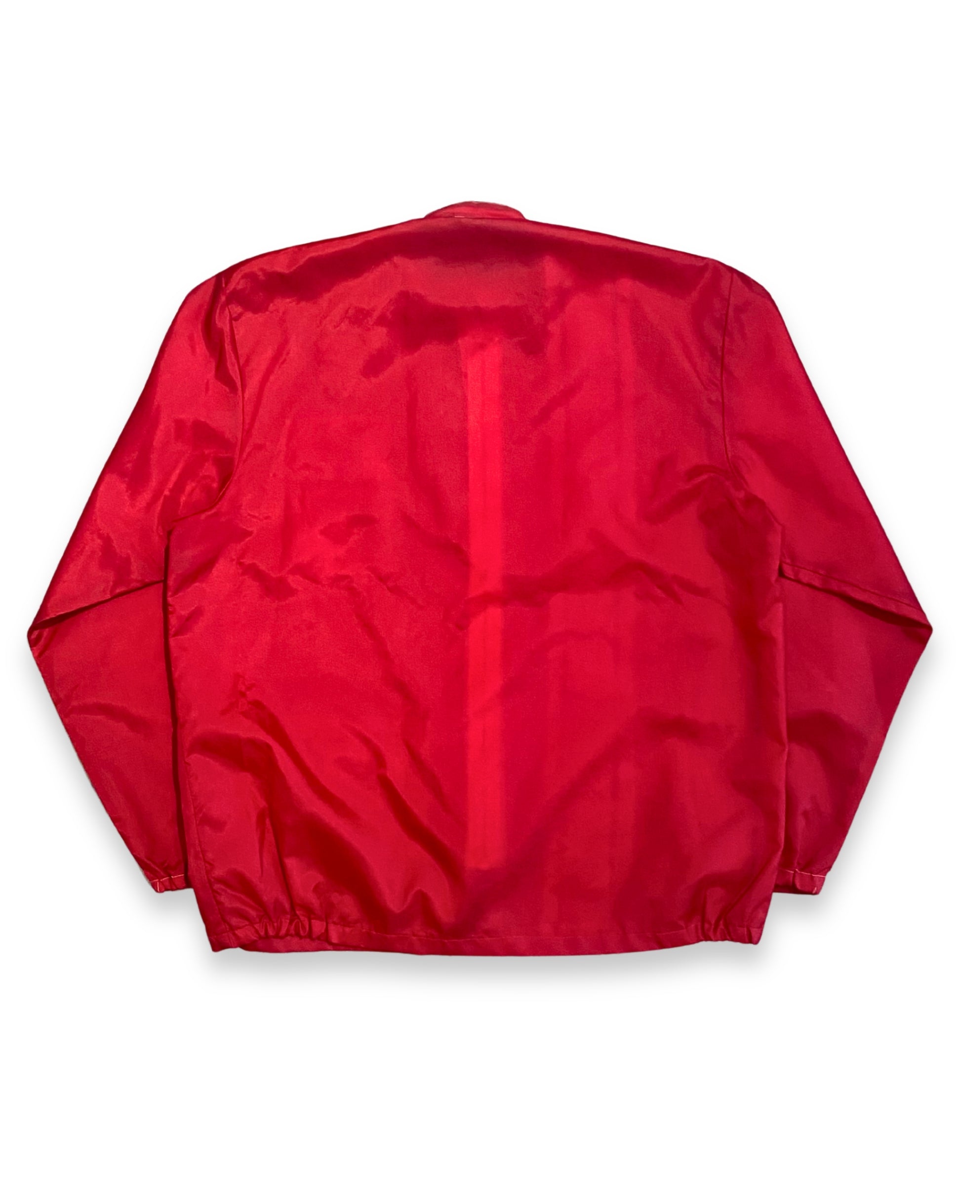 Back view of vintage red Porsche racing jacket with plain red back and elastic hem.
