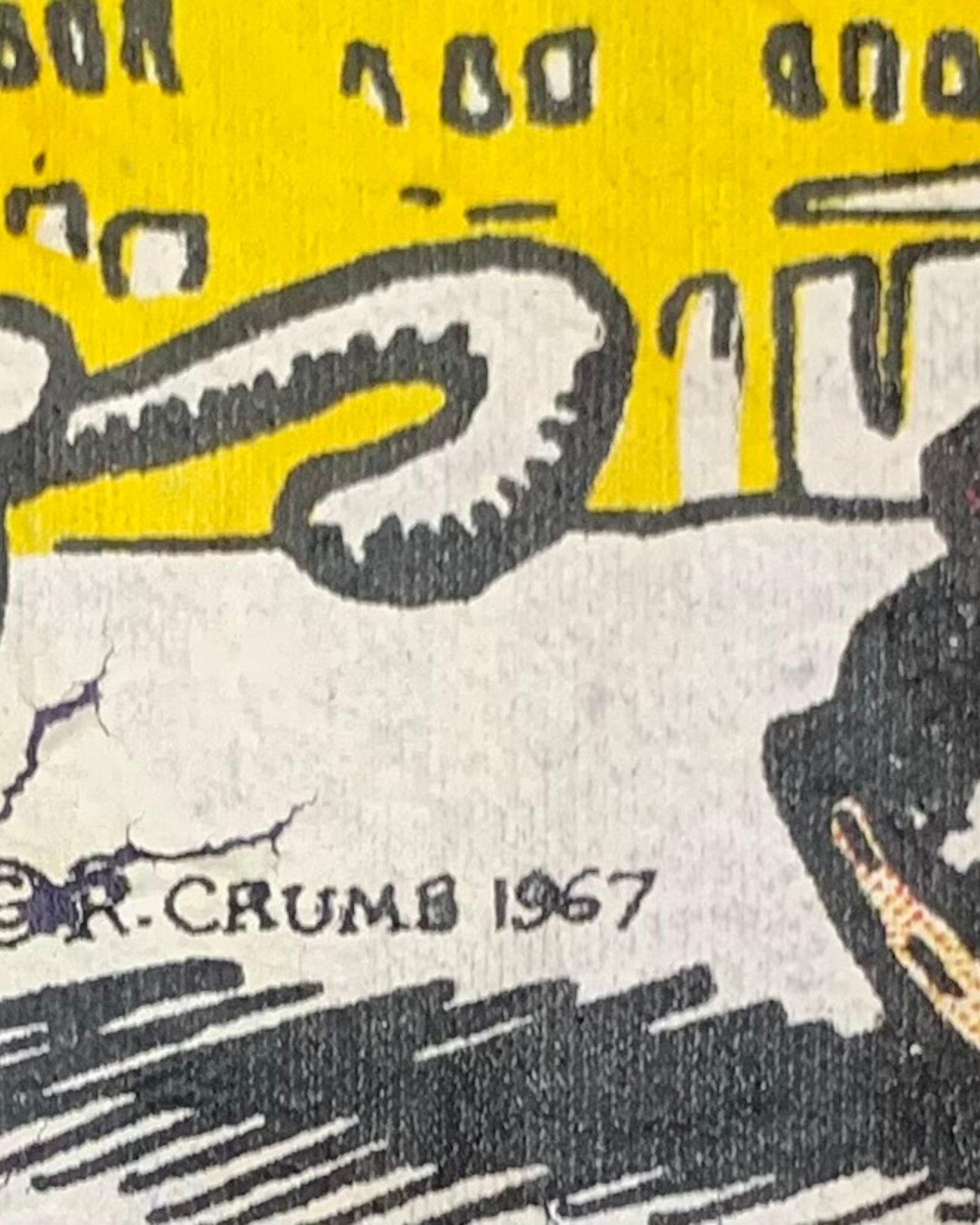 Close-up of the R. Crumb graphic showing the printed © R. Crumb 1967 mark and cracking in the surrounding artwork.
