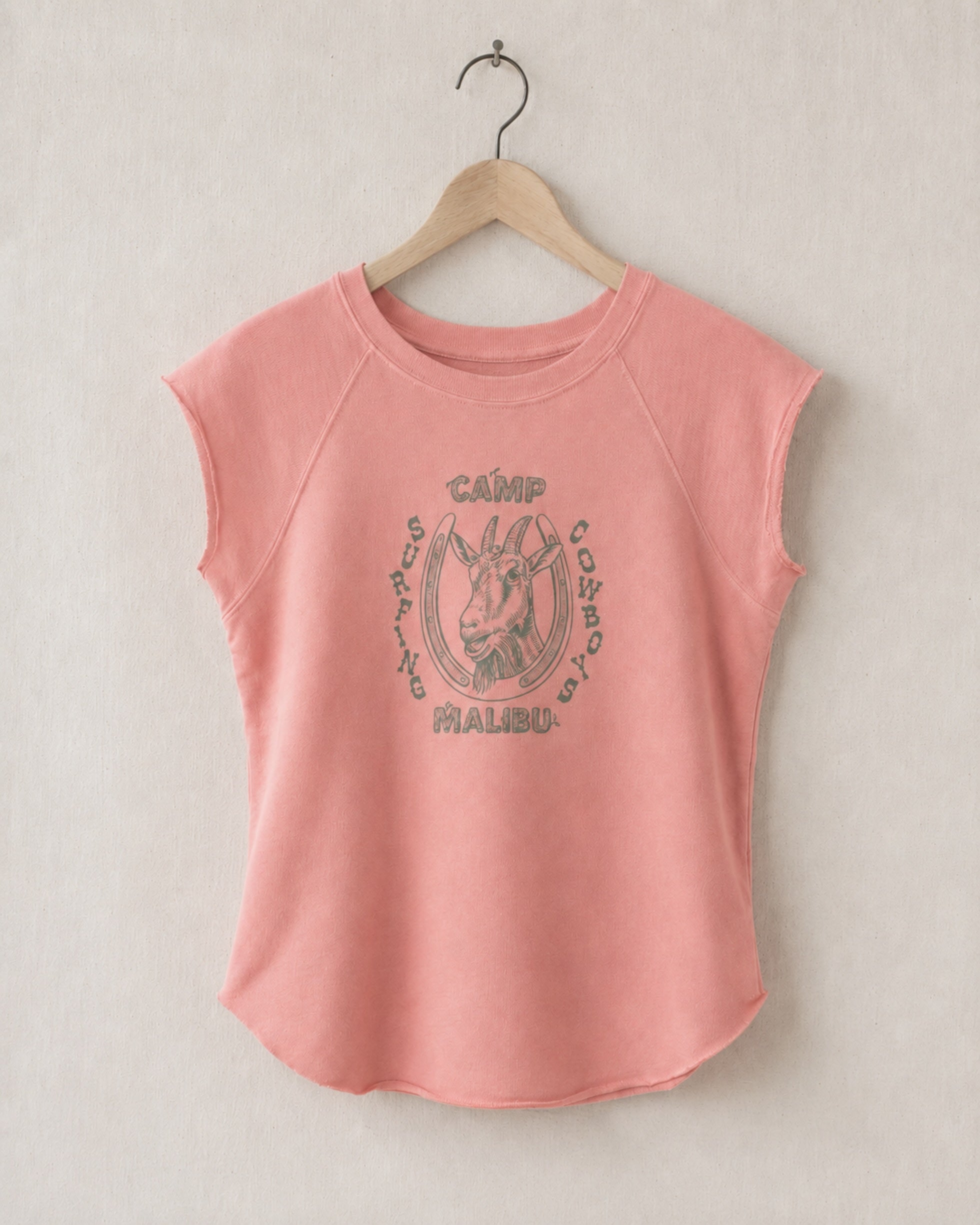 Coral pink sleeveless shirt with 'Camp Malibu' graphic on a beige background