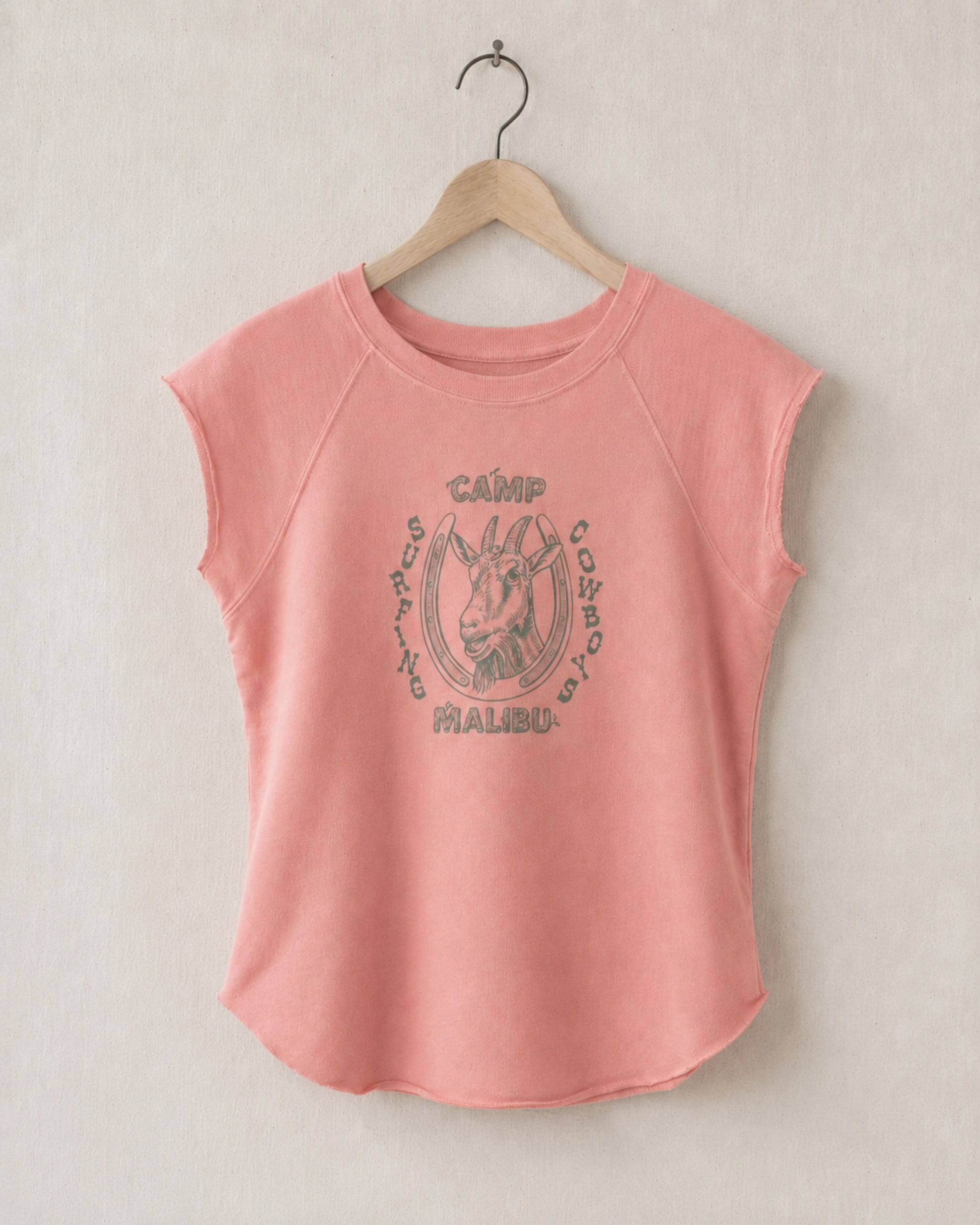 Coral pink sleeveless shirt with 'Camp Malibu' graphic on a beige background