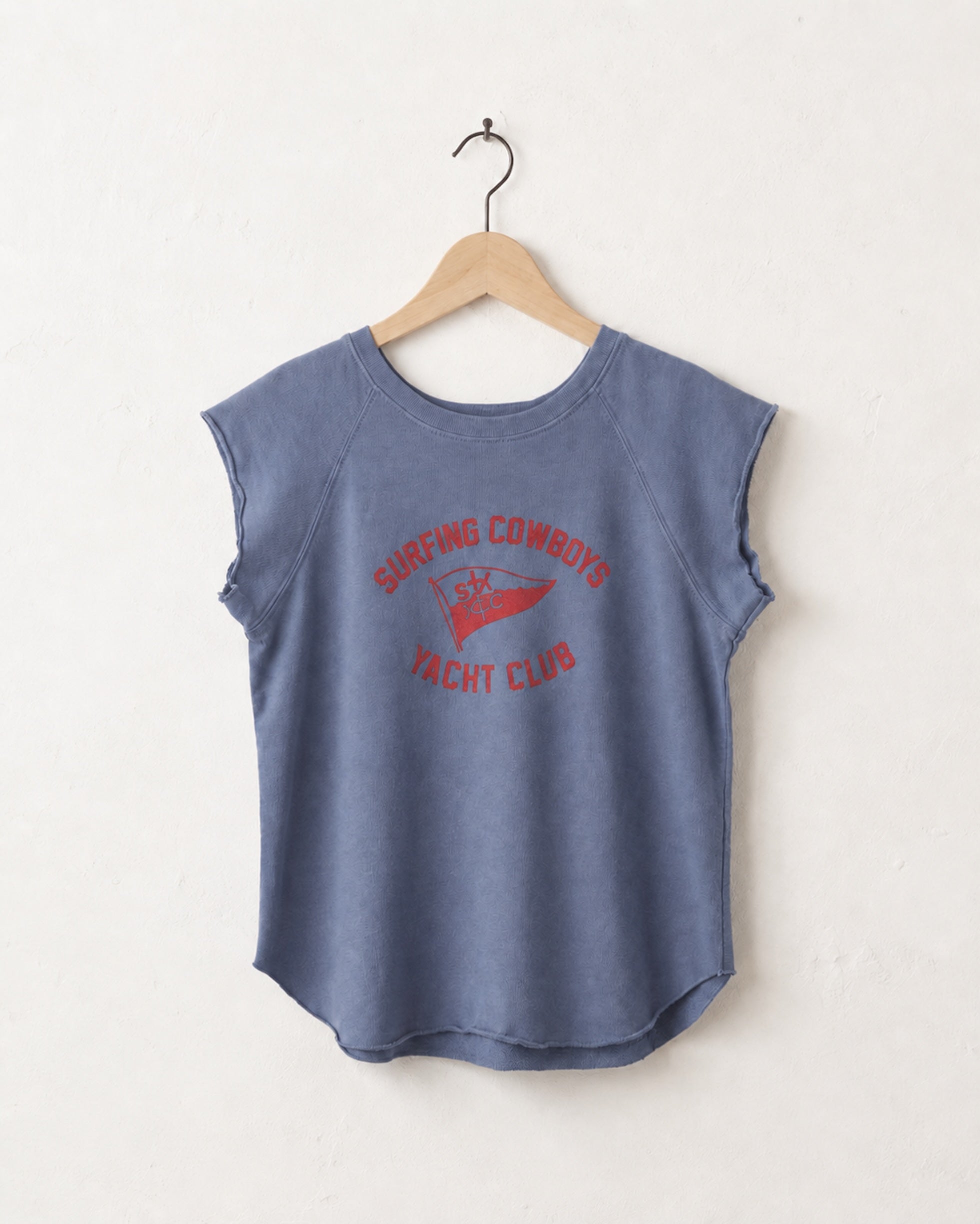 Blue sleeveless shirt with red text on a hanger against a white background