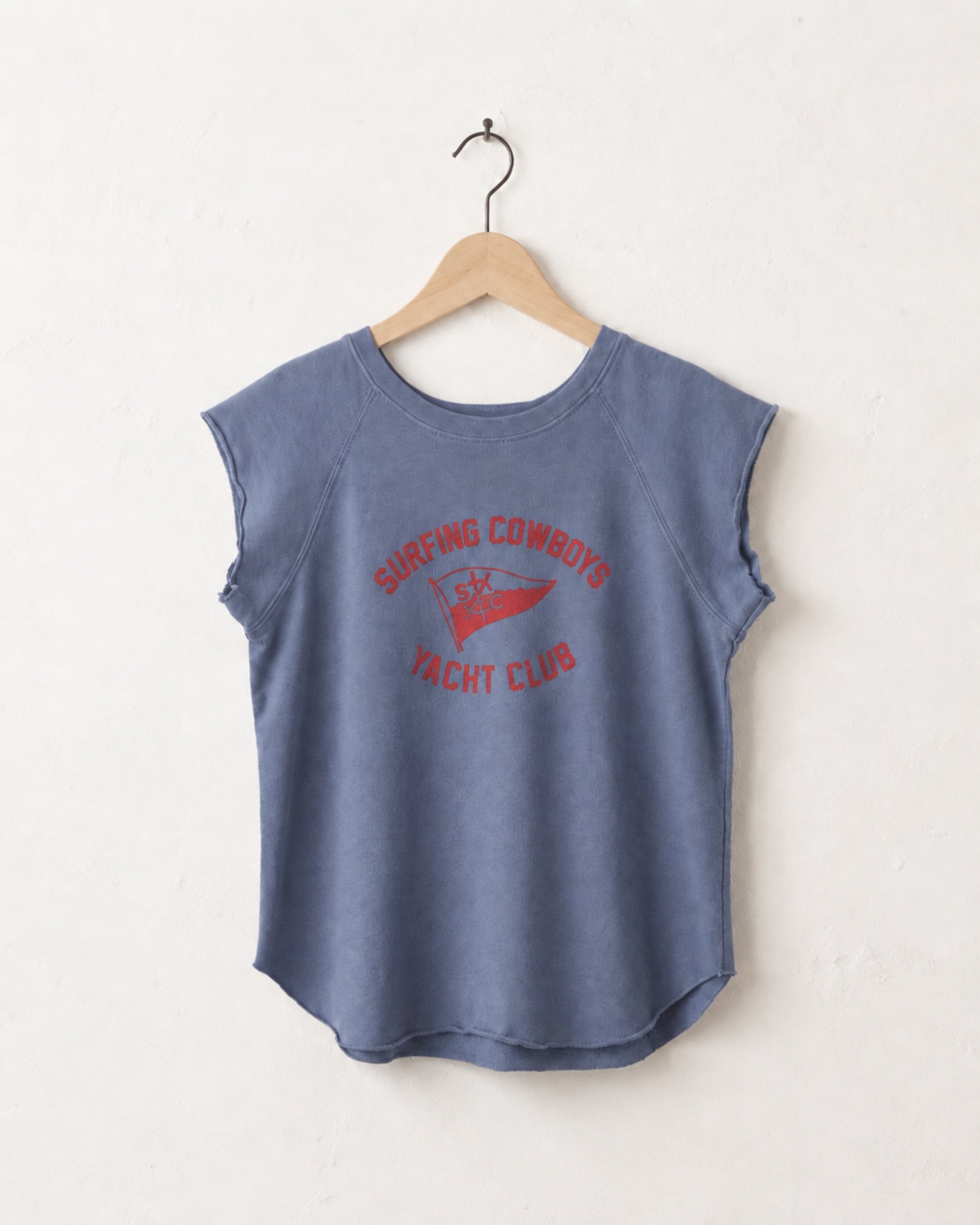 Blue sleeveless shirt with red text on a hanger against a white background
