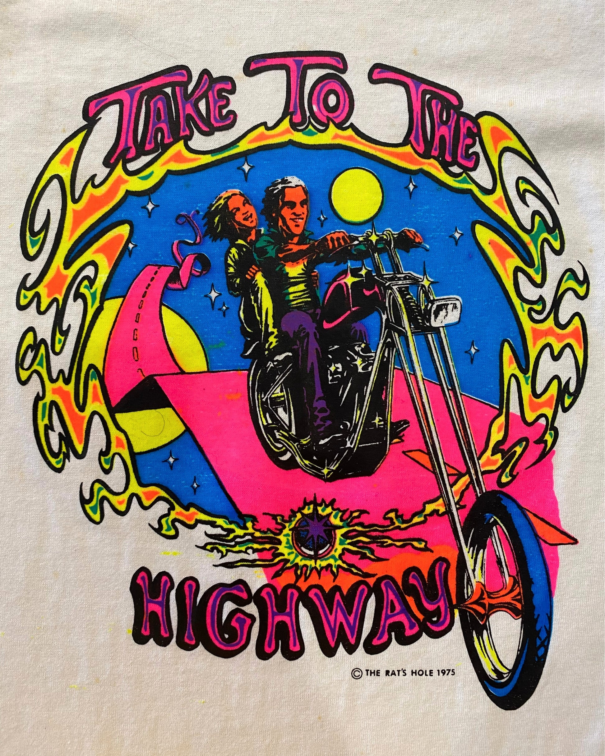 Close up of colorful chopper motorcycle graphic on front of Rat’s Hole Take To The Highway 1975 black and white raglan T-shirt.