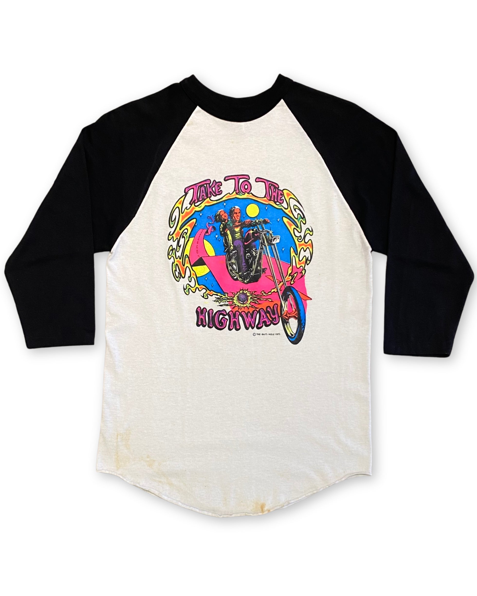 Front of Rat’s Hole Take To The Highway 1975 black and white raglan T-shirt with colorful chopper motorcycle graphic.