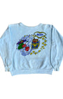 Front view of vintage 1970s light blue sweatshirt with colorful Reno casino-themed graphic.