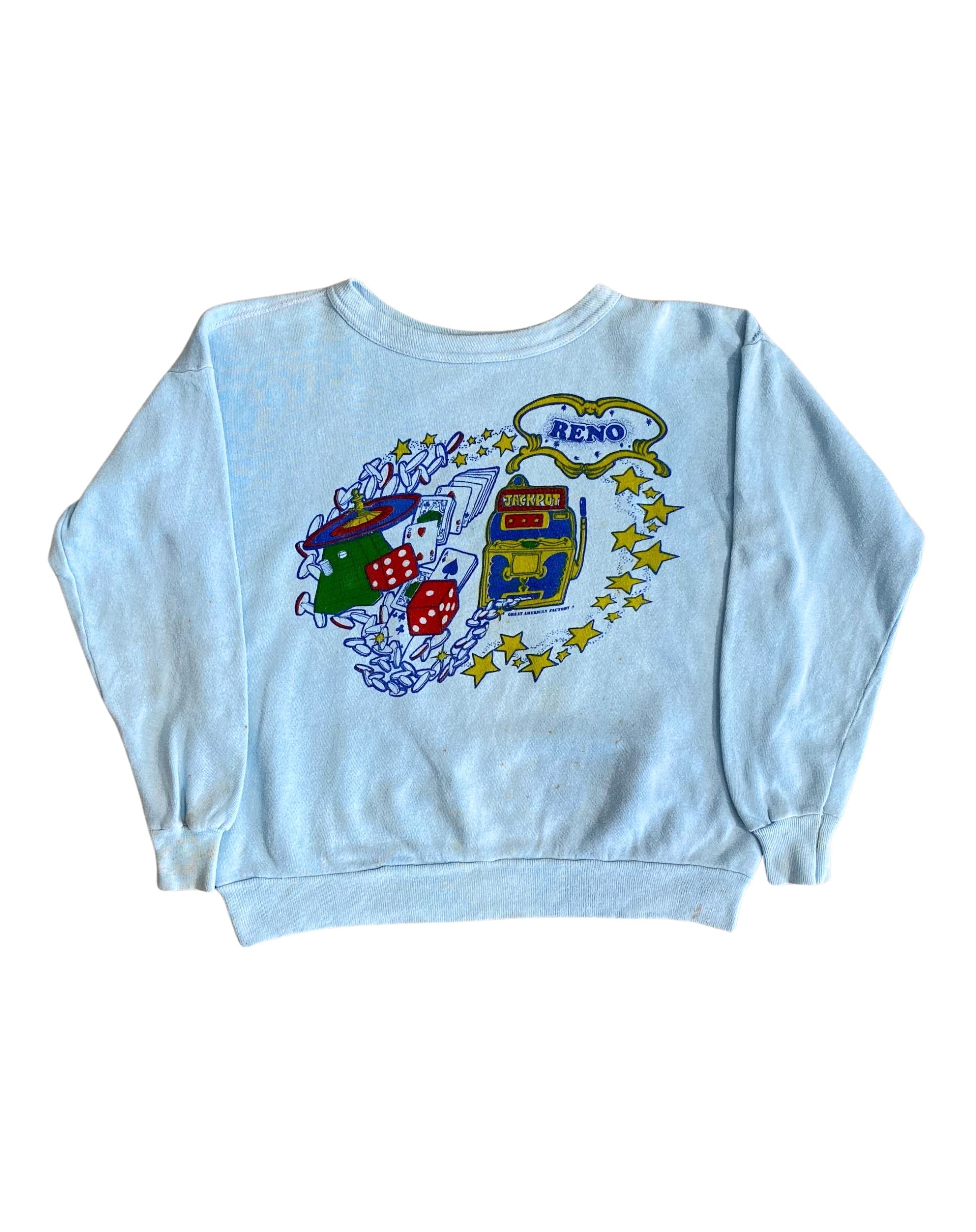 Front view of vintage 1970s light blue sweatshirt with colorful Reno casino-themed graphic.
