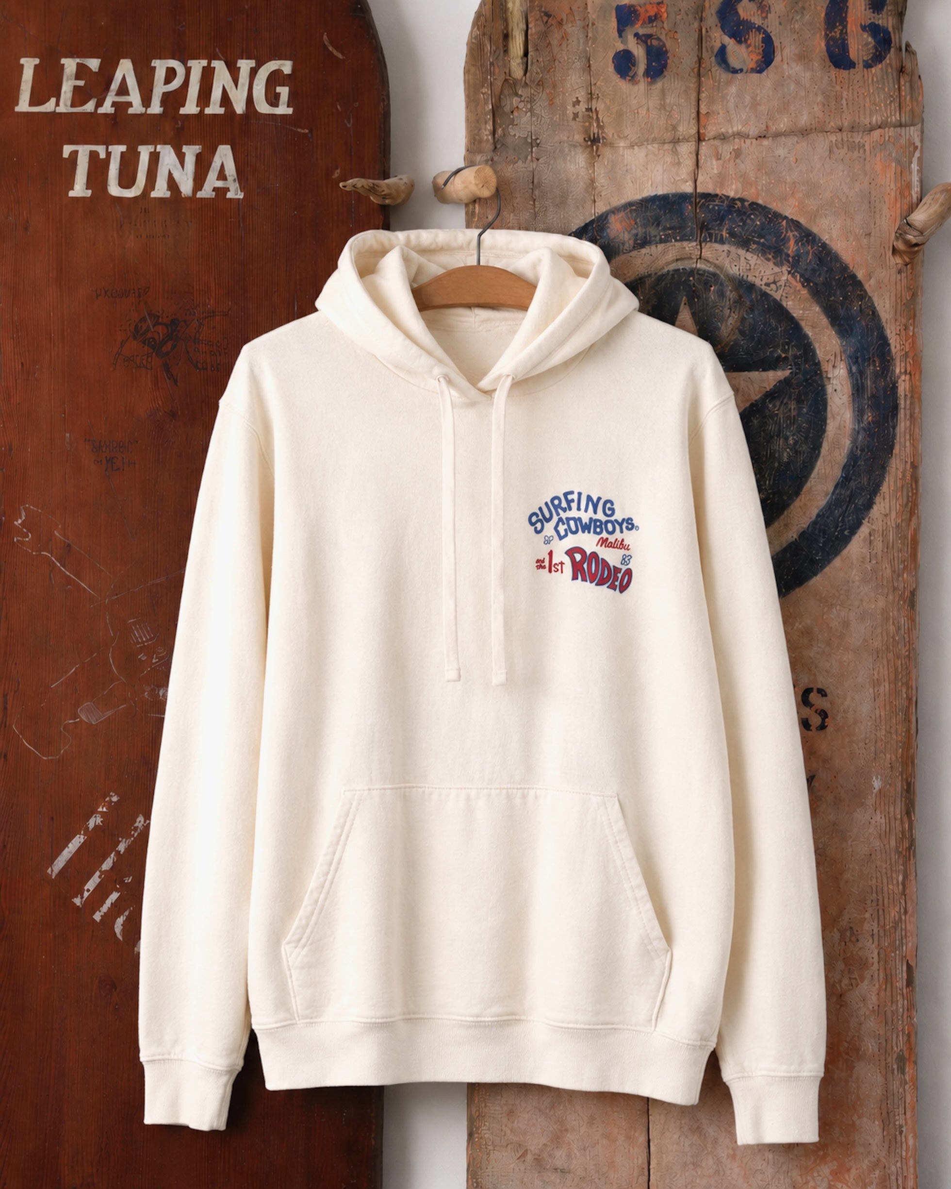 Surfing Cowboys Rodeo pull-over hoodie in cream, front view with small left-chest Rodeo graphic.