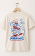 Back view of Surfing Cowboys Rodeo  t-shirt with colorful rodeo graphic design on a hanger against a white background.
