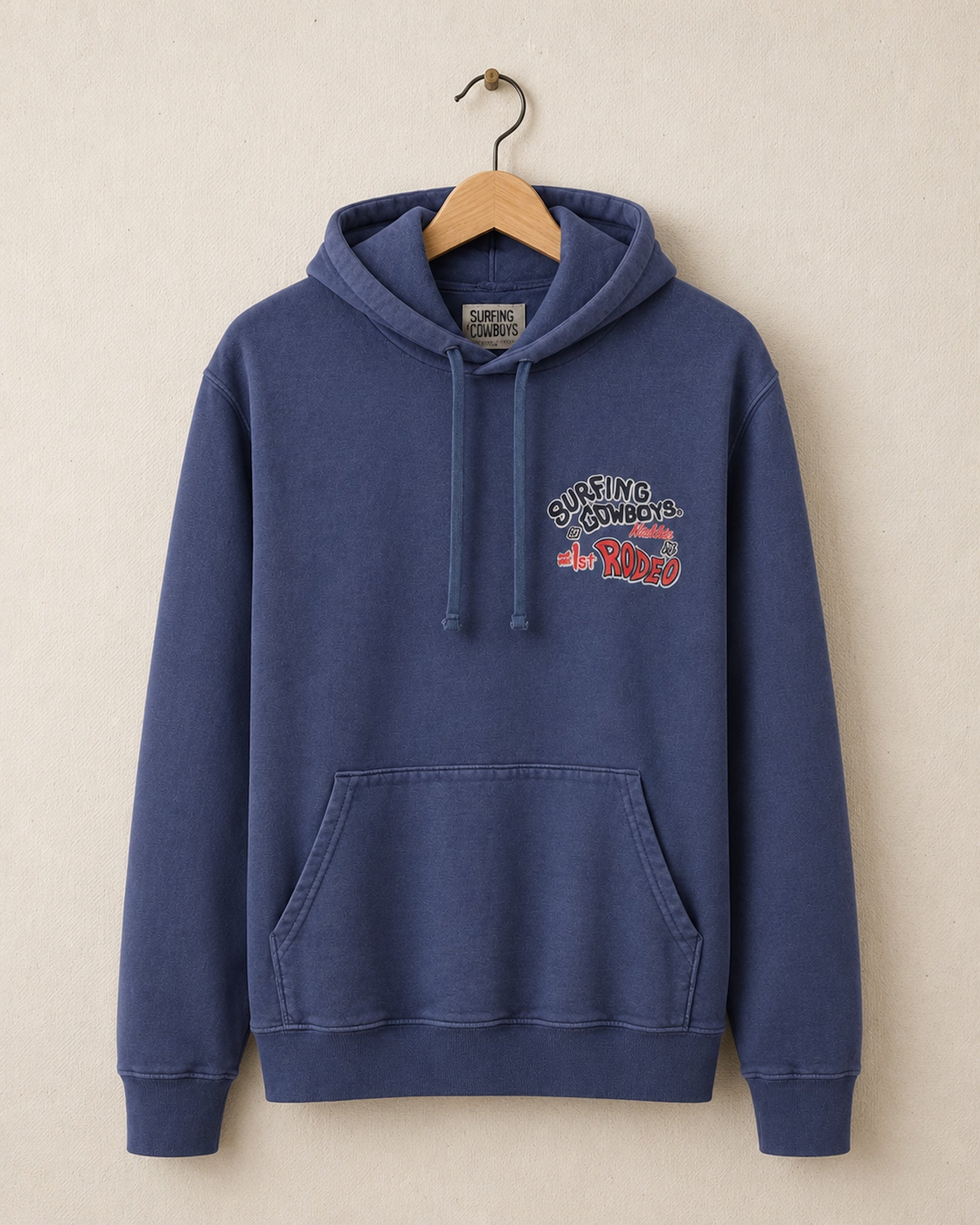 Blue hoodie with a colorful graphic on a beige background