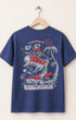 Blue t-shirt with rodeo graphic on a hanger against a white background