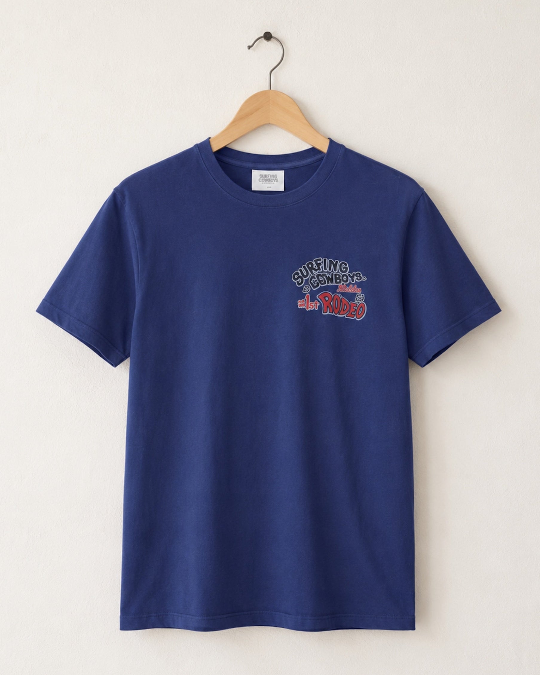Blue t-shirt with a graphic design on a hanger against a white background