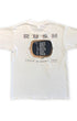 Back view of a white Rush Power Windows Tour T-shirt with a large RUSH logo, television-screen graphic, and printed December tour dates.